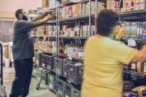 Volunteers stocking shelves at food pantry