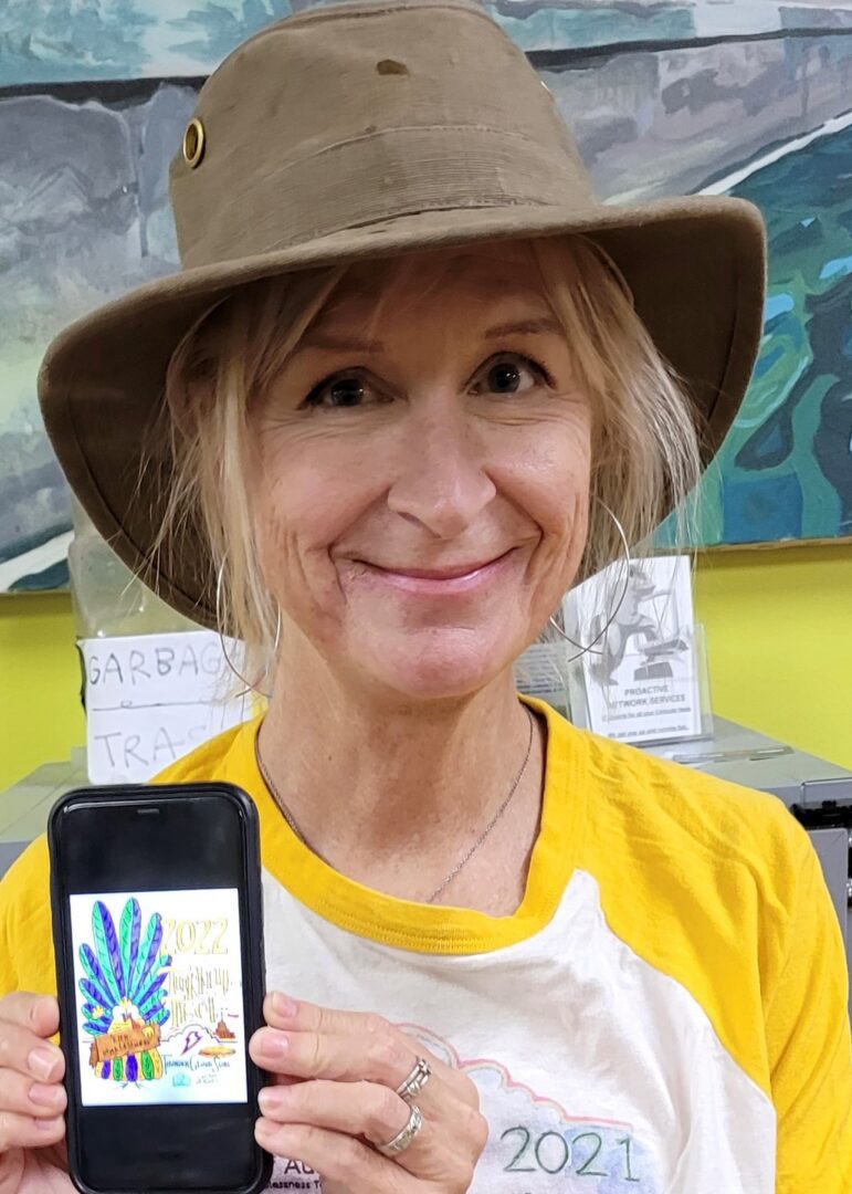Smiling person wearing hat holding phone artwork