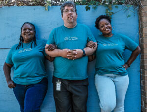 Terrie Franklin, Nathaniel Hall and Ebony Meads smiling together.