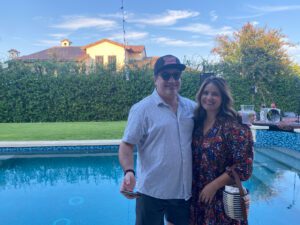 Smiling couple posing by backyard pool