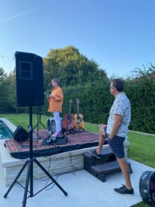 Outdoor acoustic performance by poolside with guitars