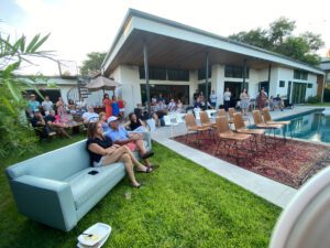 Poolside gathering at modern house with guests