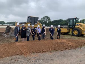 Group in hard hats at construction groundbreaking