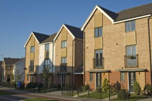 Row of modern brick townhouses on sunny street