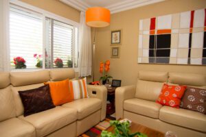 Beige living room with orange-accented pillows