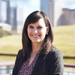 Smiling woman outdoors with city skyline