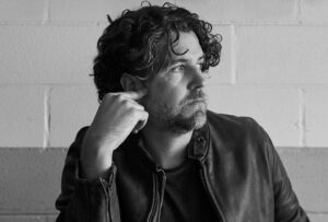 Black-and-white portrait of thoughtful man in leather jacket