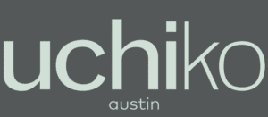 Uchiko Austin restaurant logo on gray background