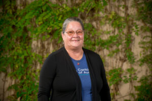 Smiling person wearing glasses outdoors