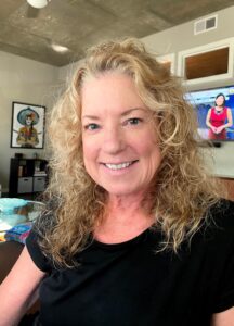 Smiling woman with curly blonde hair