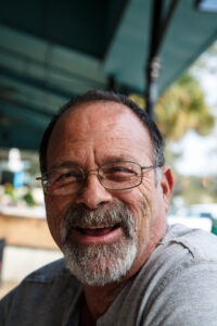 Smiling bearded man wearing glasses outdoors