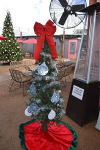 Small decorated Christmas tree with red bow