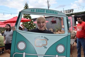 Smiling person in teal van cutout outdoors