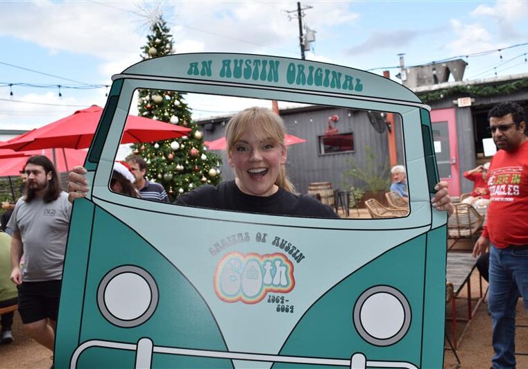 Smiling person in teal van cutout outdoors