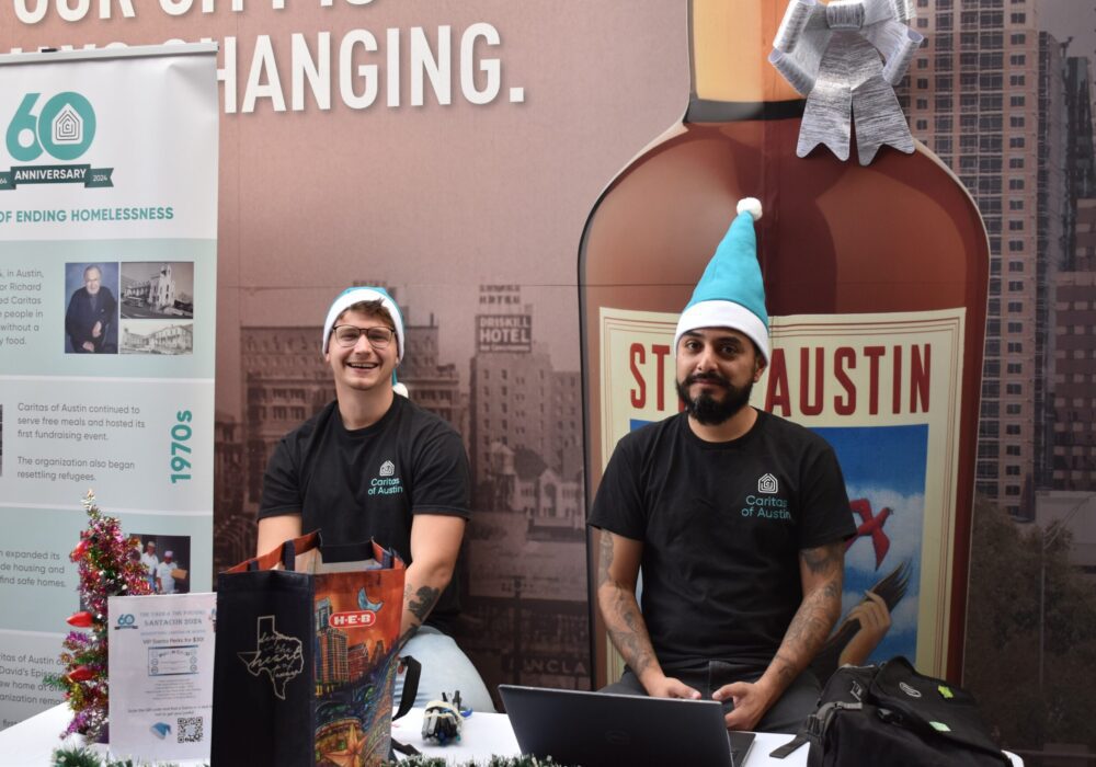 Two volunteers at booth with bottle backdrop