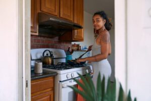 Woman cooking at stove in kitchen